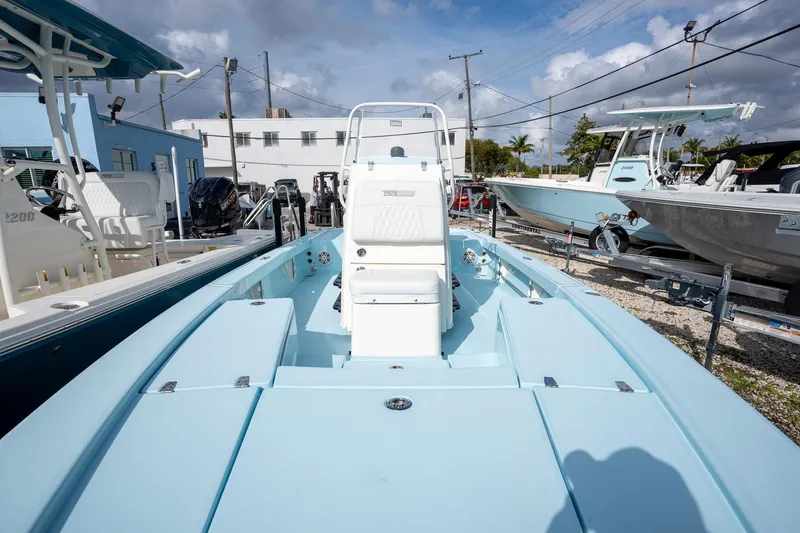 Slide: The Image of 2025 Pathfinder 2300 HPS boat in a marina, showcasing sleek design and modern features. - 15