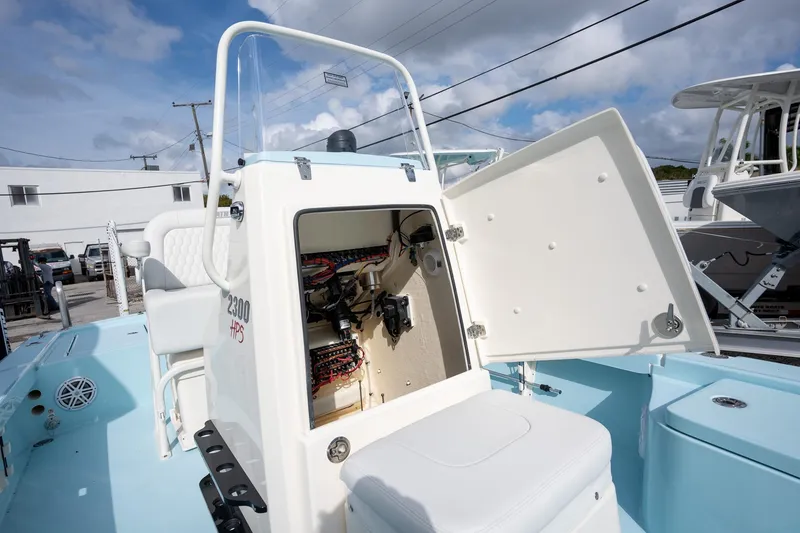 Slide: The Image of 2025 Pathfinder 2300 HPS boat with open storage compartment, showcasing interior wiring. - 17