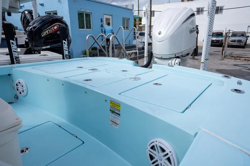 Slide: The Image of 2025 Pathfinder 2300 HPS boat with Yamaha outboard motor, light blue deck, and storage compartments. - 18