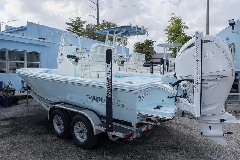 Slide: The Image of 2025 Pathfinder 2300 HPS boat on trailer, featuring Yamaha outboard motor, parked outdoors. - 4