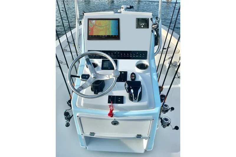 Slide: The Image of Manufacturer Provided Image: Pathfinder 2300 HPS 2025 boat console with steering wheel and navigation display. - 7