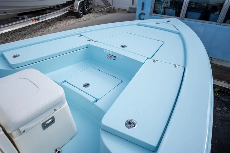 Slide: The Image of 2025 Pathfinder 2300 HPS boat interior with light blue deck and storage compartments. - 9