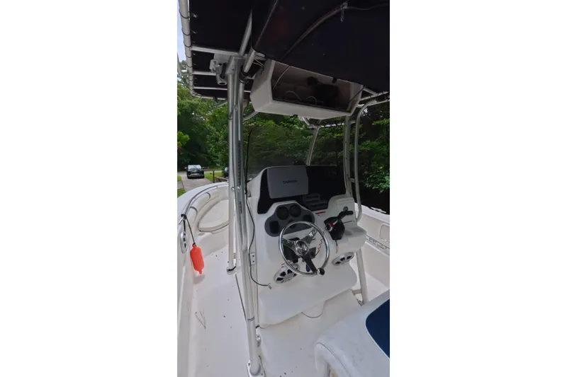 Slide: The Image of 2005 Wellcraft 232 Fisherman boat console with steering wheel and navigation equipment. - 11