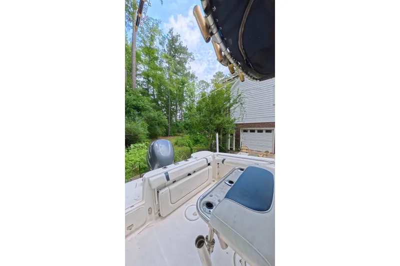 Slide: The Image of 2005 Wellcraft 232 Fisherman boat interior with lush greenery background. - 12