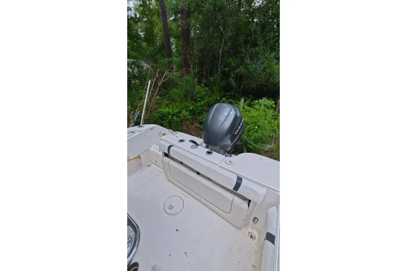 Slide: The Image of 2005 Wellcraft 232 Fisherman boat with Yamaha outboard motor in wooded area. - 13