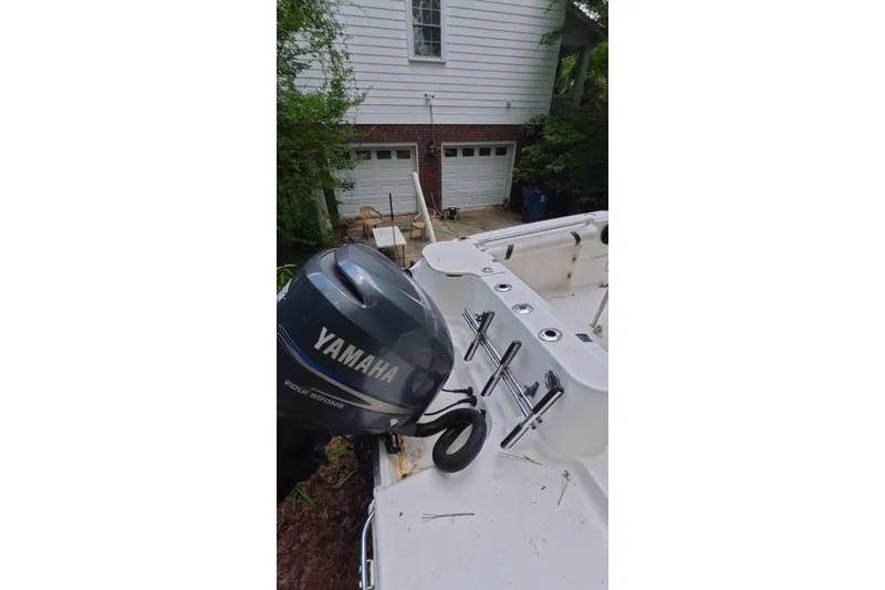 Slide: The Image of 2005 Wellcraft 232 Fisherman boat with Yamaha outboard motor in residential driveway. - 14
