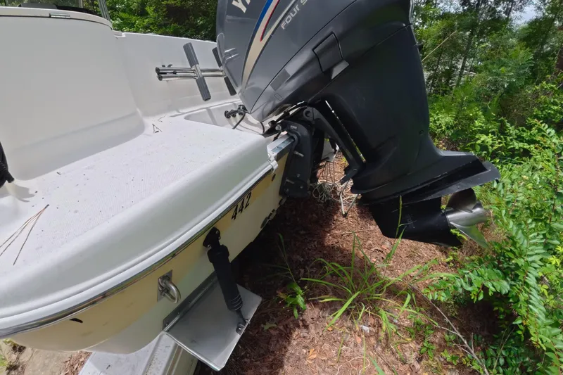 Slide: The Image of 2005 Wellcraft 232 Fisherman boat with outboard motor in a wooded area. - 16
