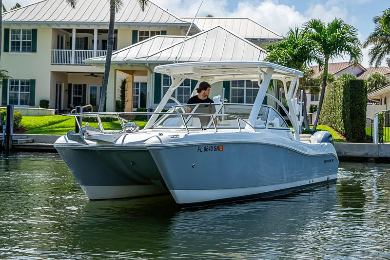 Slide: The Image of WorldCat 255 DC boat cruising near waterfront homes, 2020 model. - 1