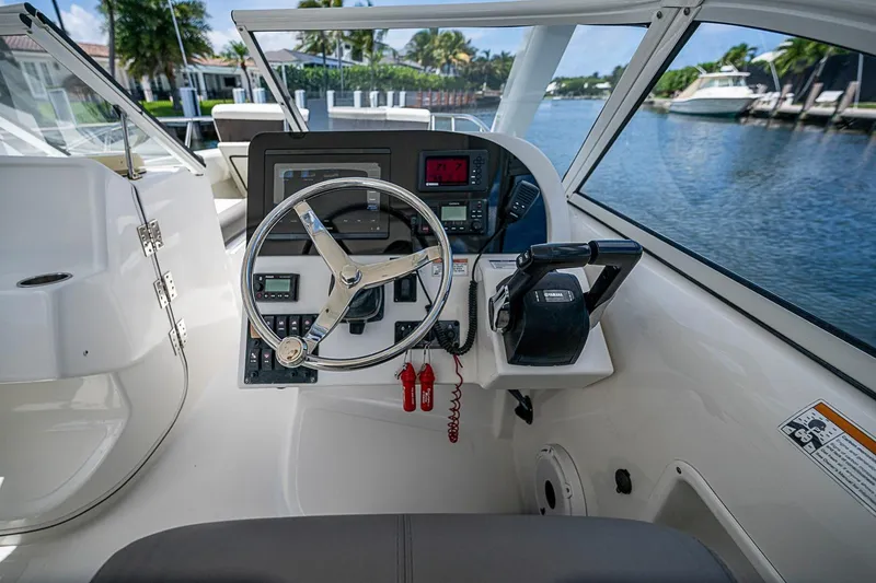Slide: The Image of Cockpit of 2020 WorldCat 255 DC boat with steering wheel and control panel. - 10