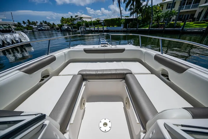 Slide: The Image of Spacious seating area on a 2020 WorldCat 255 DC boat, docked by waterfront homes. - 11