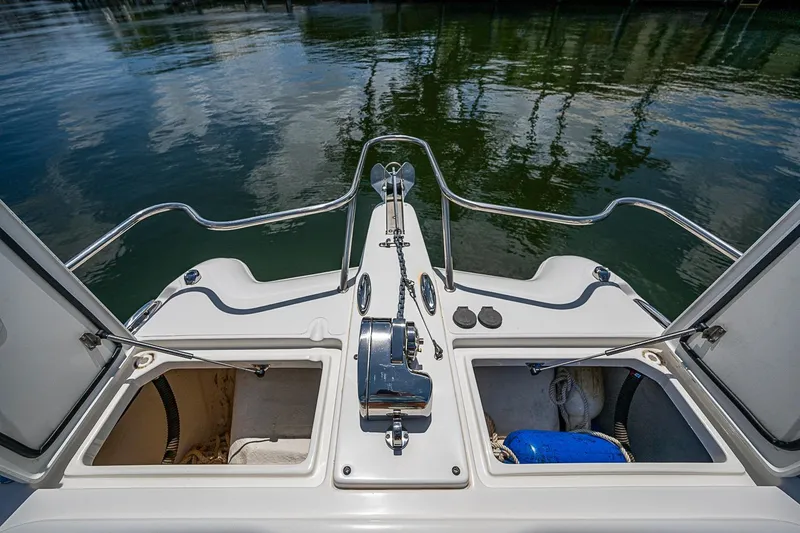 Slide: The Image of WorldCat 255 DC boat deck with open storage compartments, 2020 model, on calm water. - 12
