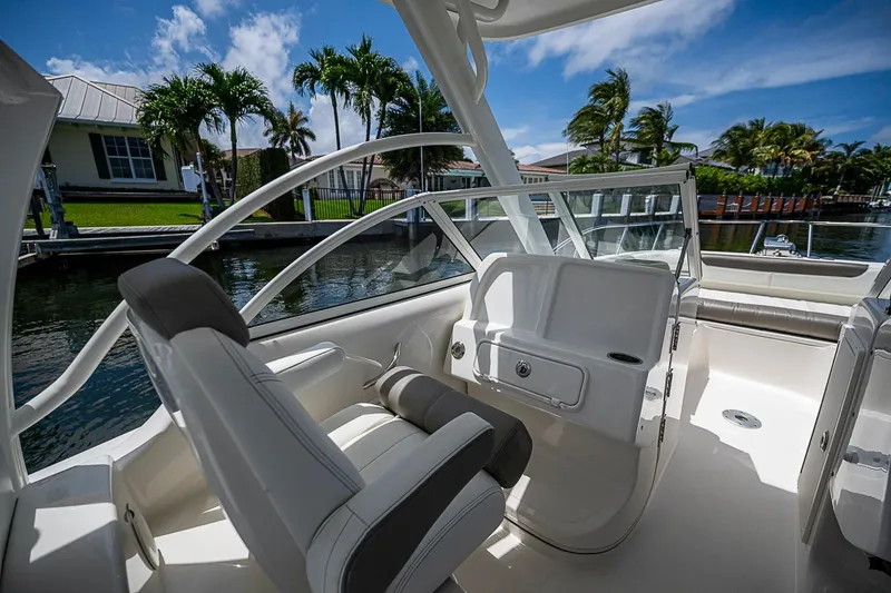 Slide: The Image of Interior view of a 2020 WorldCat 255 DC boat with luxurious seating and waterfront backdrop. - 17