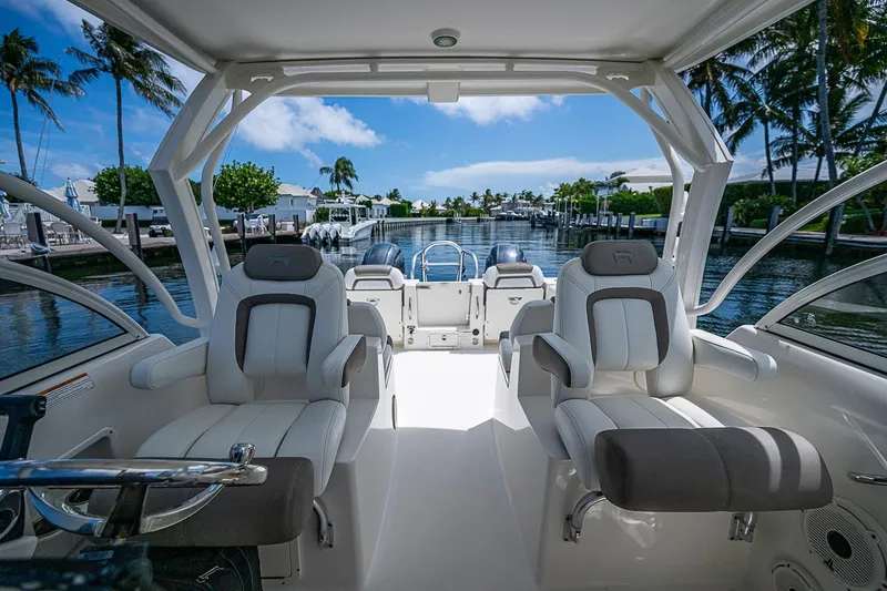 Slide: The Image of Interior view of a 2020 WorldCat 255 DC boat with luxurious seating and scenic marina backdrop. - 18
