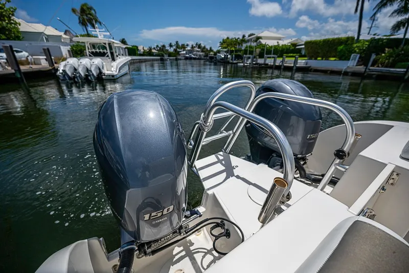 Slide: The Image of Twin Yamaha 150 engines on a 2020 WorldCat 255 DC boat in a sunny marina. - 20