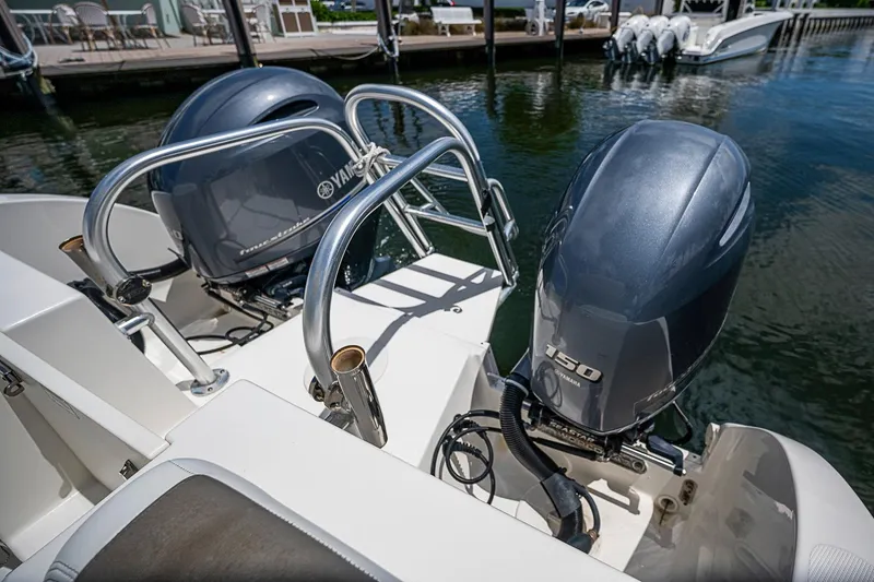 Slide: The Image of Twin Yamaha outboard motors on a 2020 WorldCat 255 DC boat at a dock. - 21