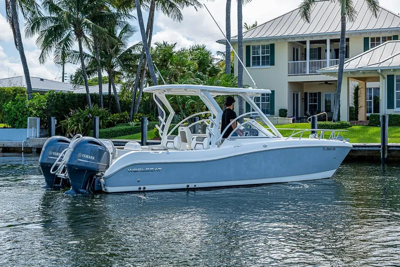 Slide: The Image of 2020 WorldCat 255 DC boat cruising near waterfront home with palm trees. - 3