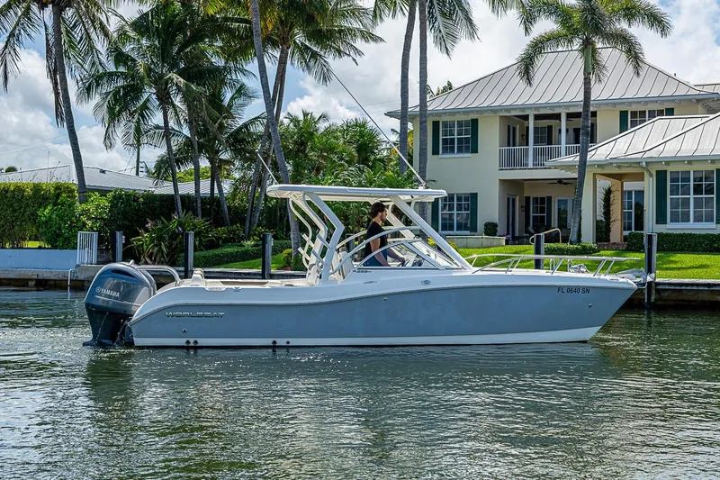 Slide: The Image of 2020 WorldCat 255 DC boat cruising near waterfront home with palm trees. - 4