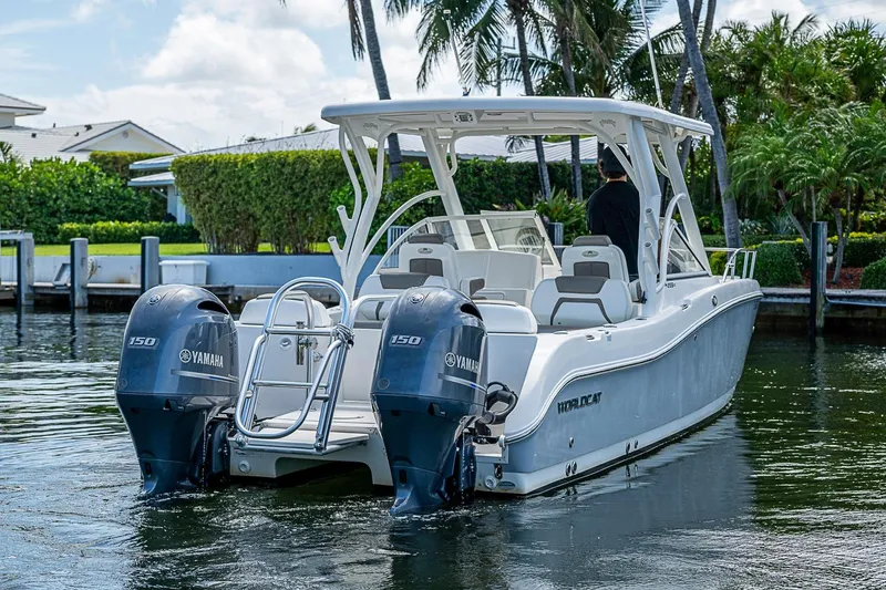 Slide: The Image of WorldCat 255 DC boat with twin Yamaha engines docked in a scenic waterfront setting. - 5