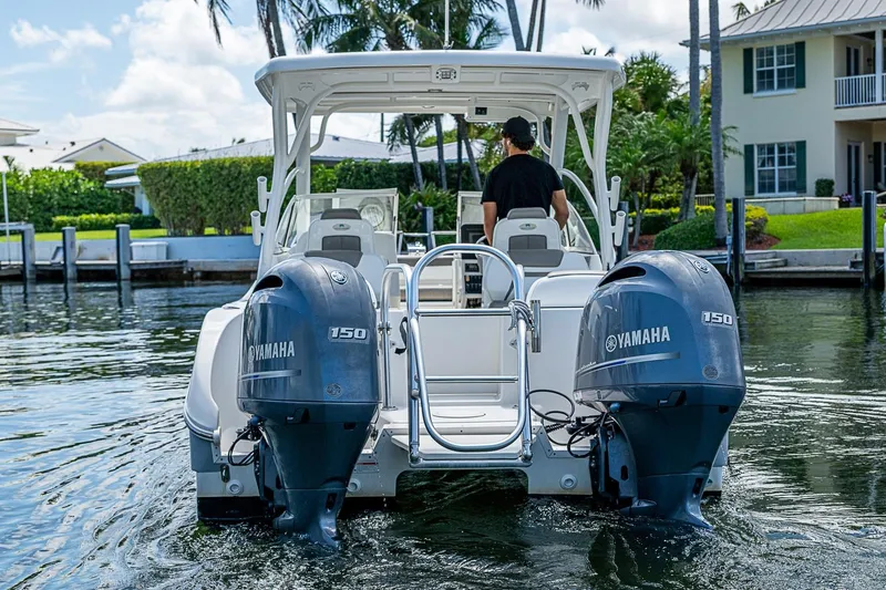 Slide: The Image of WorldCat 255 DC boat with dual Yamaha 150 engines on a sunny day. - 6