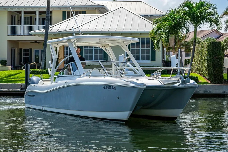 Slide: The Image of 2020 WorldCat 255 DC boat docked near waterfront home with palm trees. - 8