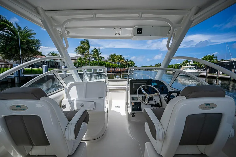 Slide: The Image of Interior view of a 2020 WorldCat 255 DC boat, featuring dual helm seats and a sleek dashboard. - 9