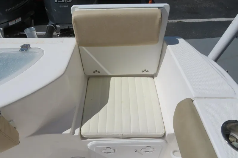 Slide: The Image of 2017 Sea Fox 256 Voyager boat seat with beige cushions and storage compartment. - 22