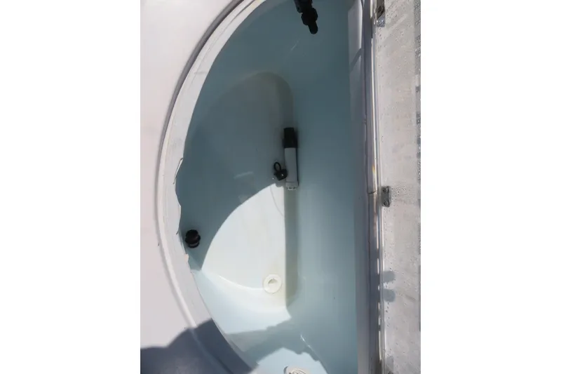 Slide: The Image of Livewell of a 2017 Sea Fox 256 Voyager boat, featuring a clean, white interior. - 23