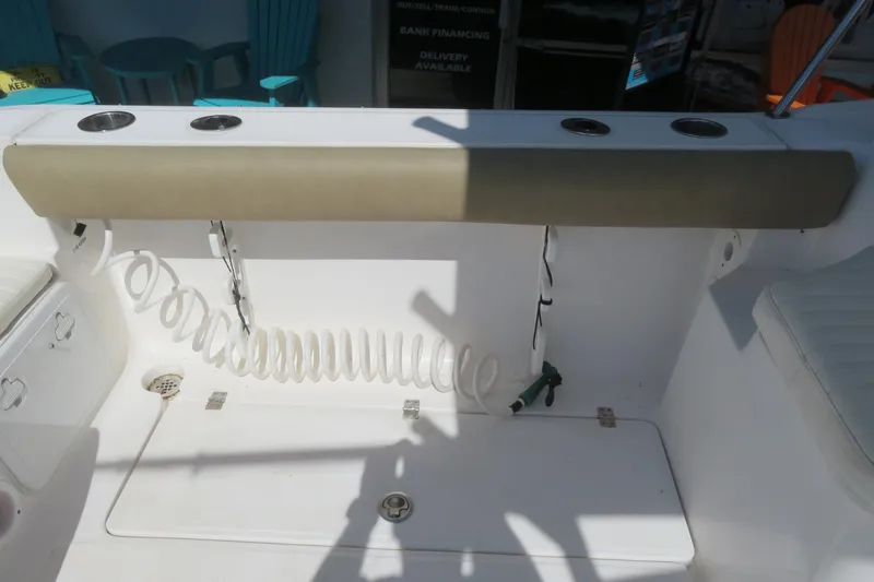 Slide: The Image of 2017 Sea Fox 256 Voyager boat interior with rod holders and coiled hose. - 25