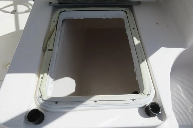 Slide: The Image of Open hatch on 2017 Sea Fox 256 Voyager boat deck, showing interior compartment. - 28