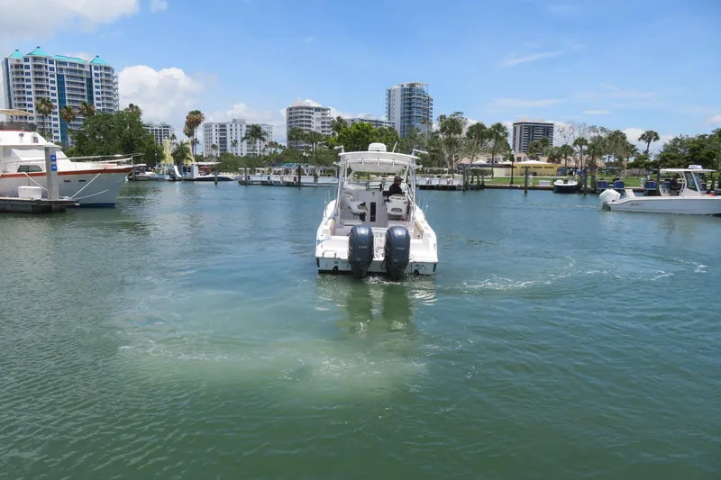Slide: The Image of 2017 Sea Fox 256 Voyager navigating a marina with cityscape background. - 4