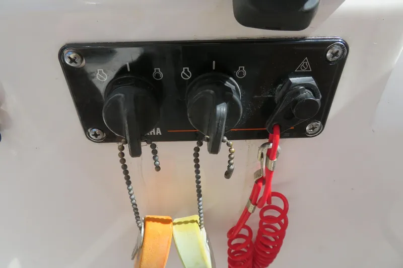 Slide: The Image of Control panel of a 2017 Sea Fox 256 Voyager boat with switches and safety lanyard. - 41