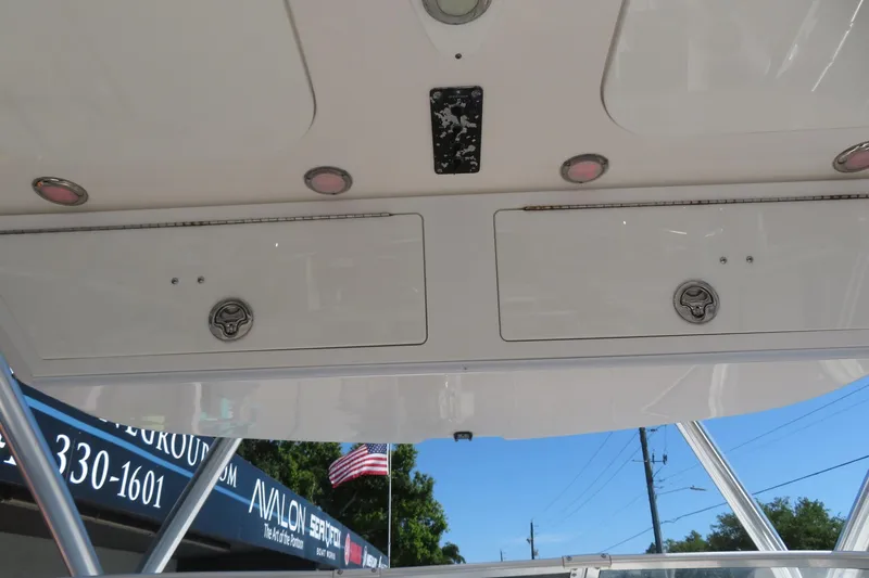 Slide: The Image of 2017 Sea Fox 256 Voyager boat storage compartments with American flag in background. - 47