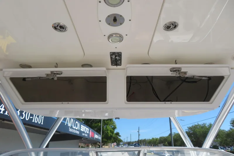 Slide: The Image of 2017 Sea Fox 256 Voyager boat dashboard with storage compartments and controls. - 51