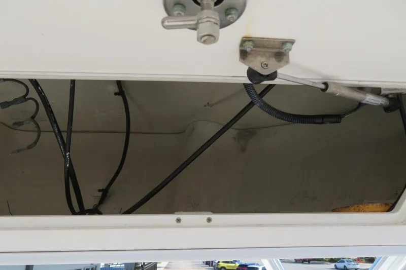 Slide: The Image of Open storage compartment in a 2017 Sea Fox 256 Voyager boat, showing wiring and fittings. - 53