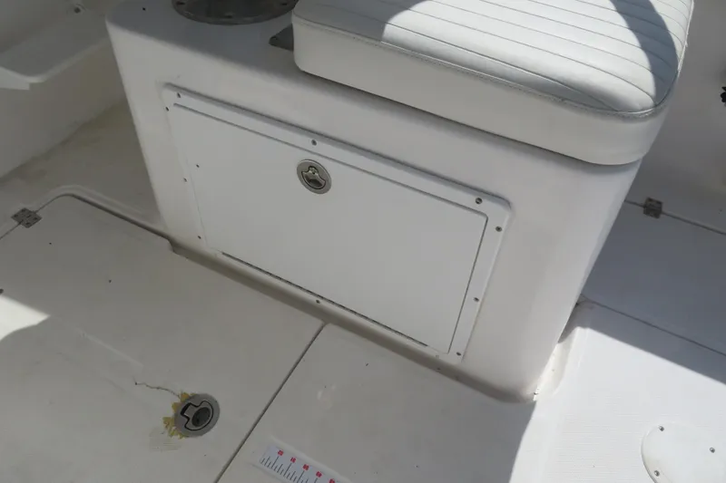 Slide: The Image of 2017 Sea Fox 256 Voyager boat interior with storage compartment and cushioned seat. - 54