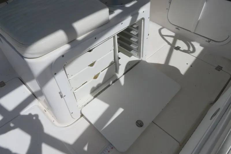Slide: The Image of 2017 Sea Fox 256 Voyager boat interior with open storage compartment and seating. - 56