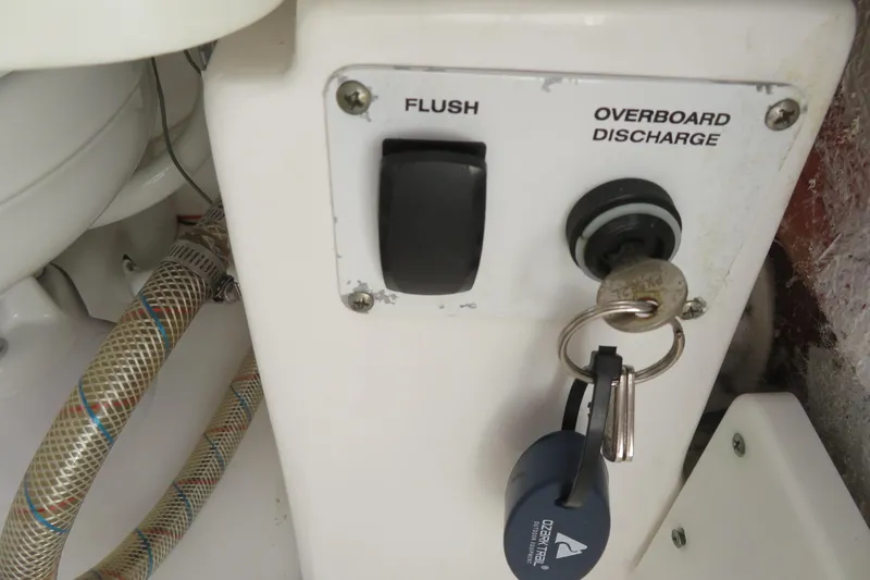 Slide: The Image of Control panel with flush and overboard discharge switches on a 2017 Sea Fox 256 Voyager. - 65
