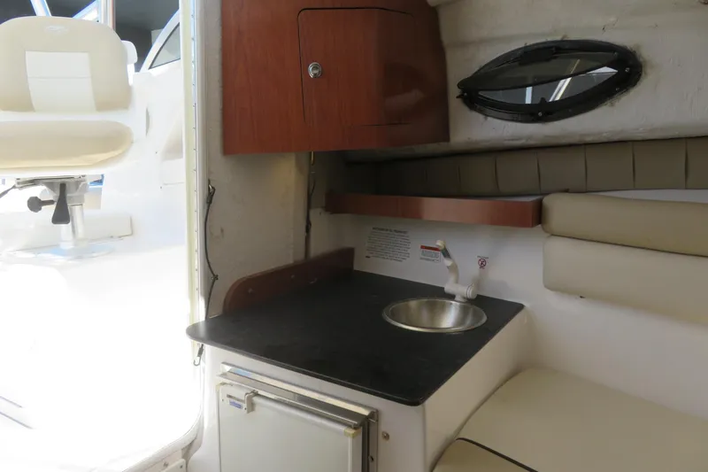 Slide: The Image of Interior of 2017 Sea Fox 256 Voyager boat with sink, cabinet, and seating area. - 66