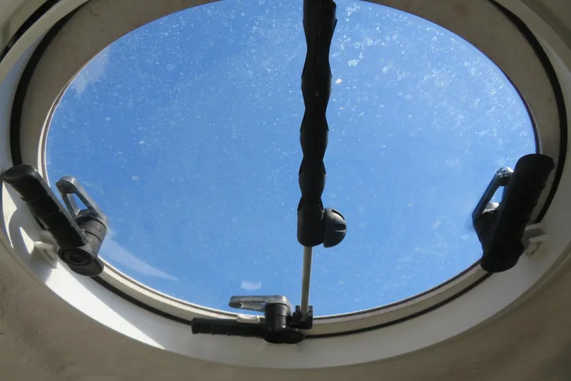 Slide: The Image of Porthole view from 2017 Sea Fox 256 Voyager boat, showcasing clear blue sky. - 70