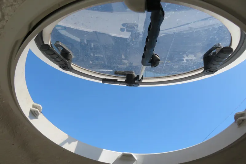 Slide: The Image of Porthole view from 2017 Sea Fox 256 Voyager boat, showcasing clear blue sky. - 71