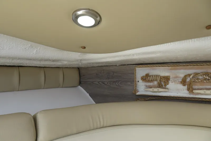 Slide: The Image of Interior of 2017 Sea Fox 256 Voyager boat with beige seating and nautical decor. - 72