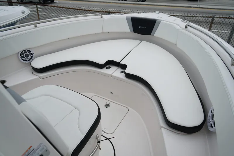 Slide: The Image of 2025 Robalo R222 Center Console boat with white cushioned seating area. - 12