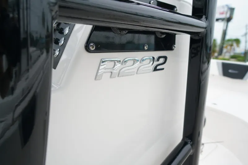 Slide: The Image of 2025 Robalo R222 Center Console boat, close-up of model emblem and sleek design. - 15