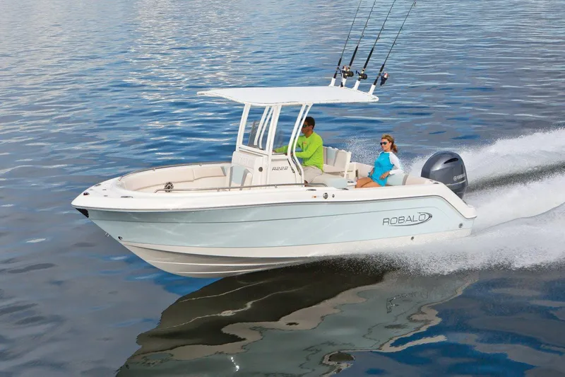 Slide: The Image of 2025 Robalo R222 Center Console boat cruising on calm water. - 16