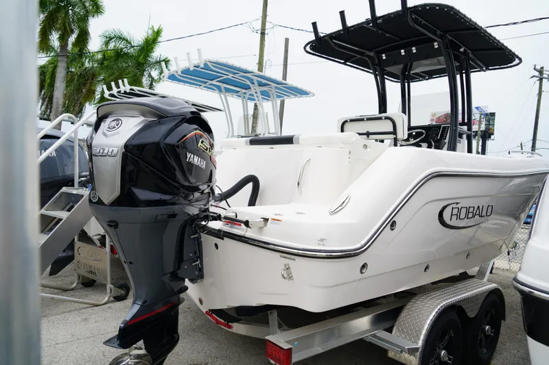 Slide: The Image of 2025 Robalo R222 Center Console boat with Yamaha engine on trailer. - 2