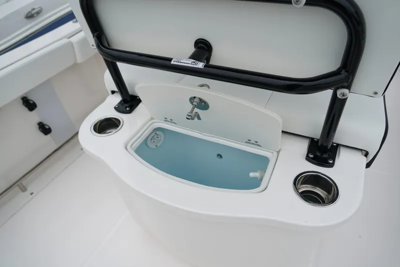 Slide: The Image of 2025 Robalo R222 Center Console boat with integrated livewell and cup holders. - 7