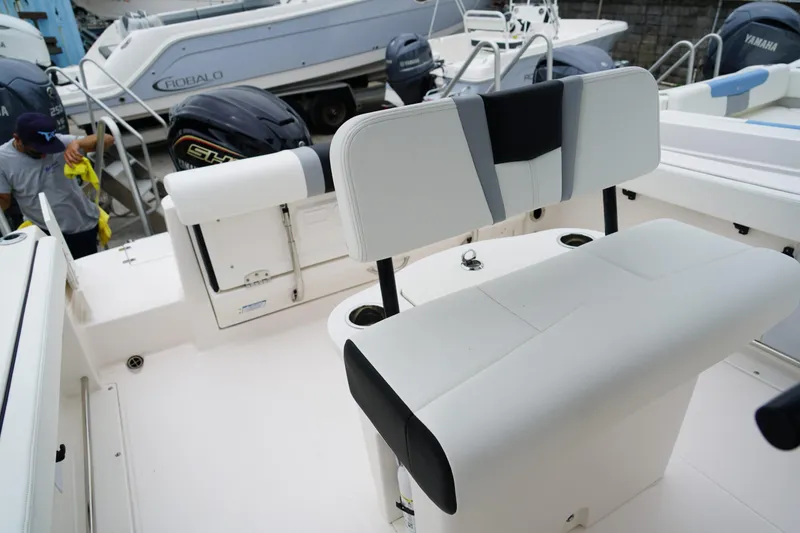 Slide: The Image of 2025 Robalo R222 Center Console boat interior with seating and engine view. - 8