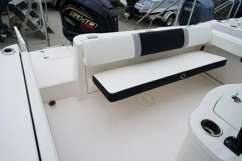 Slide: The Image of 2025 Robalo R222 Center Console boat interior with Yamaha engine, featuring seating and storage. - 9