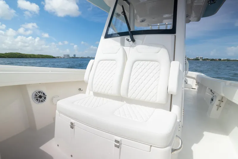 Slide: The Image of 2026 Regulator 31 boat with white seating, ocean view, and clear blue sky. - 11
