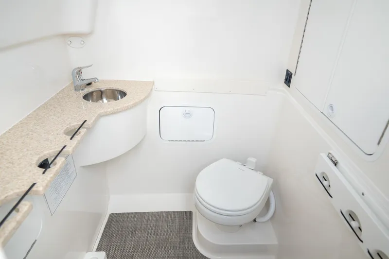 Slide: The Image of 2026 Regulator 31 boat bathroom with sink, toilet, and storage compartments. - 12